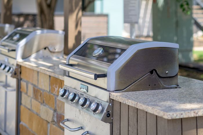 Sleek outdoor BBQ grill station with stainless steel design and modern features, perfect for vibrant gatherings.