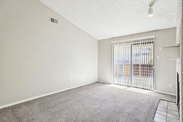 Bright and airy living space with sliding glass doors, offering abundant natural light and seamless outdoor access.