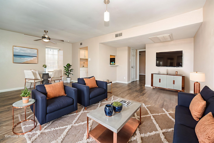 Chic living room with elegant furniture, modern decor, and sleek hardwood floors, perfect for style and comfort. Virtually staged for inspiration.
