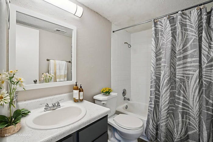 Modern, virtually staged bathroom with elegant fixtures, stylish vanity, and a chic shower curtain, creating a fresh and inviting atmosphere.