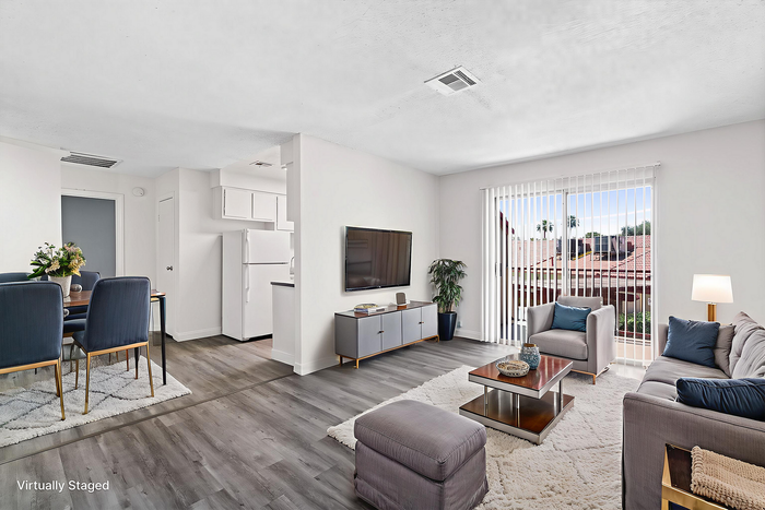 Virtually staged living room showcasing modern layout with elegant furnishings, sleek flooring, and abundant natural light from large windows.