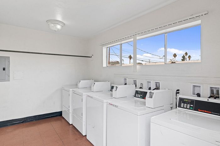 Bright and spacious laundry room with modern washing machines, offering a convenient and efficient wash experience.