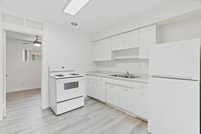 Bright and airy kitchen with modern white cabinets, sleek countertops, and a spacious layout.