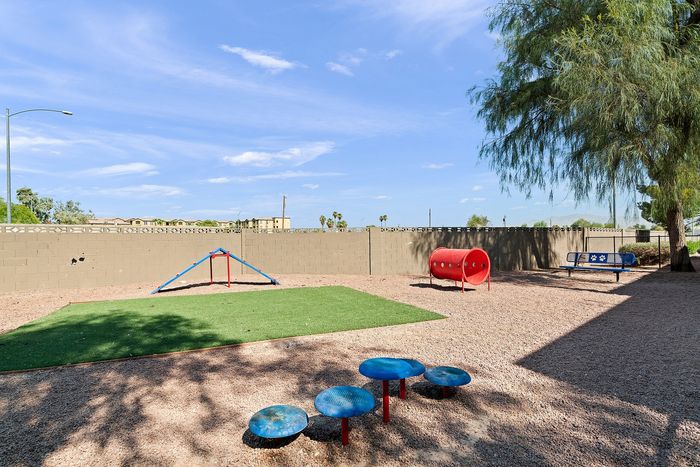Inviting outdoor play area featuring vibrant playground equipment and lush greenery, perfect for family fun and relaxation.