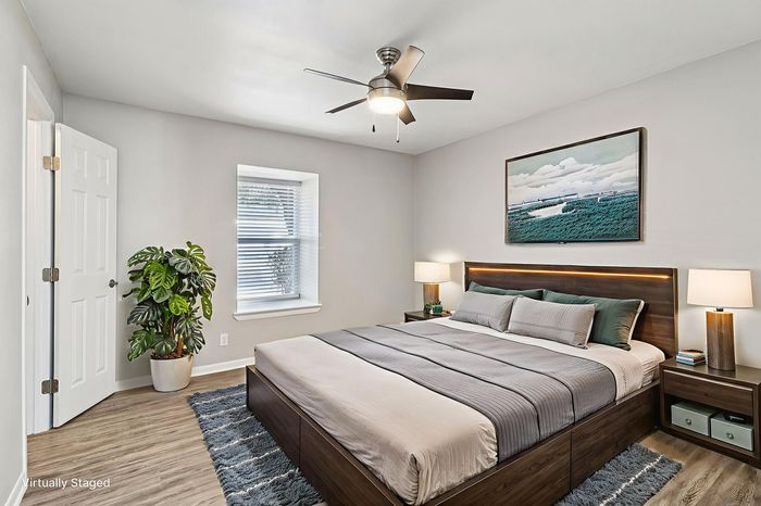 Chic bedroom interior with modern decor, showcasing a comfortable bed, elegant lighting, and stylish furnishings.