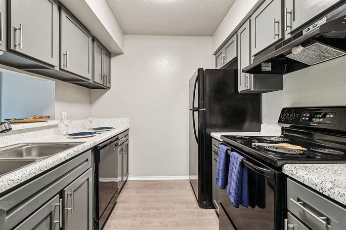 Sleek modern kitchen featuring elegant gray cabinetry, polished granite countertops, and state-of-the-art appliances.