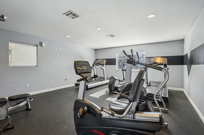 Modern fitness center with state-of-the-art exercise machines, bright lighting, and sleek design.