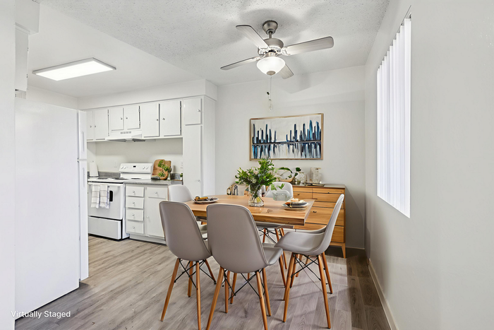 Charming kitchen and dining area with a modern touch, featuring sleek chairs, stylish table setting, and a bright, airy atmosphere.