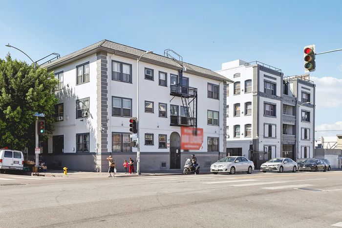 Charming urban apartment building with classic architecture, situated on a vibrant city corner.