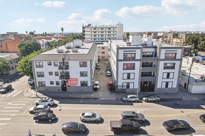 Charming urban apartment buildings with vibrant street view, featuring stylish architecture and convenient city living.