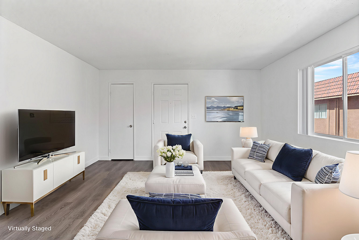 Chic and airy living room with modern furniture, plush white sofas, and elegant decor, showcasing a serene and inviting atmosphere.