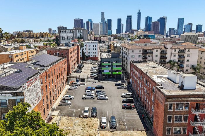 Vibrant cityscape view of downtown buildings with spacious urban parking and historic architecture, perfect for city living.