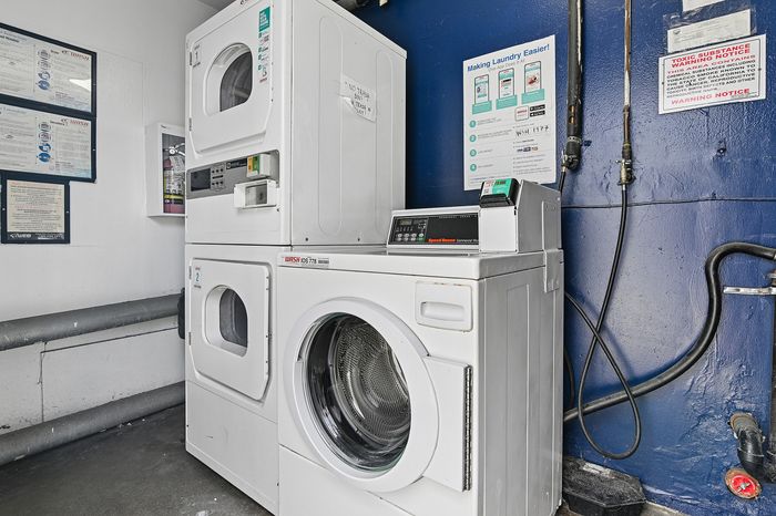 Modern laundry room with stackable washers and dryers, offering efficient and convenient laundry services.