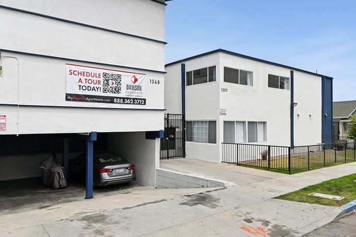 Modern apartment building exterior with convenient parking and inviting gated entrance. Schedule a tour today at Dawson Apartments.
