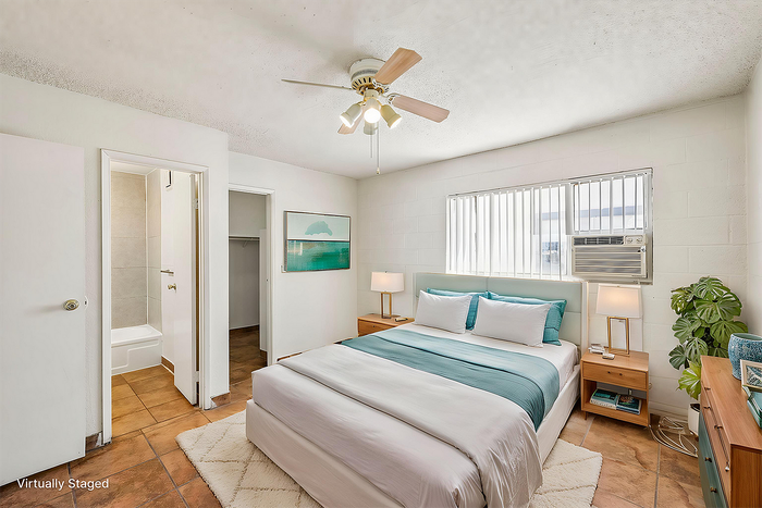 Bright and airy bedroom with a plush queen bed, stylish decor, and convenient ensuite bathroom.