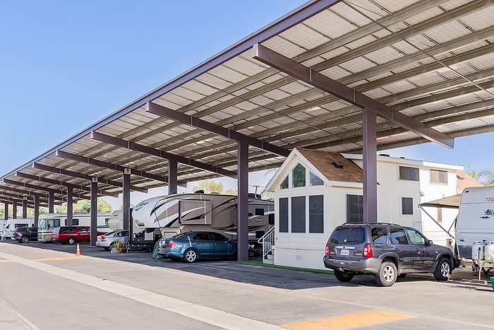 Modern RV park showcasing covered parking, contemporary tiny homes, and vibrant outdoor living spaces.