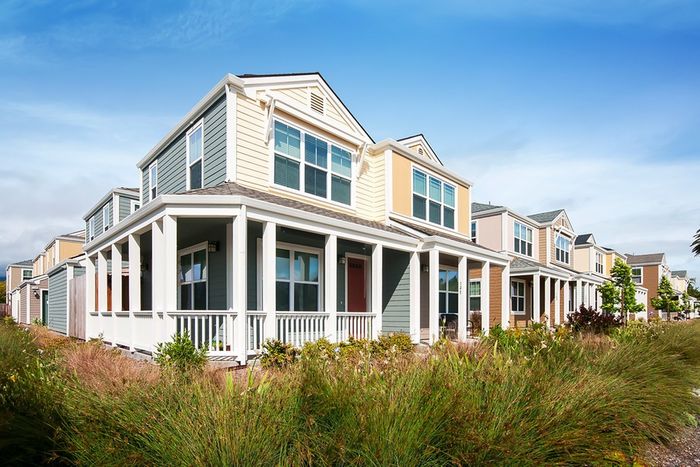 Home exterior with wrap-around porch and well-maintained landscaping