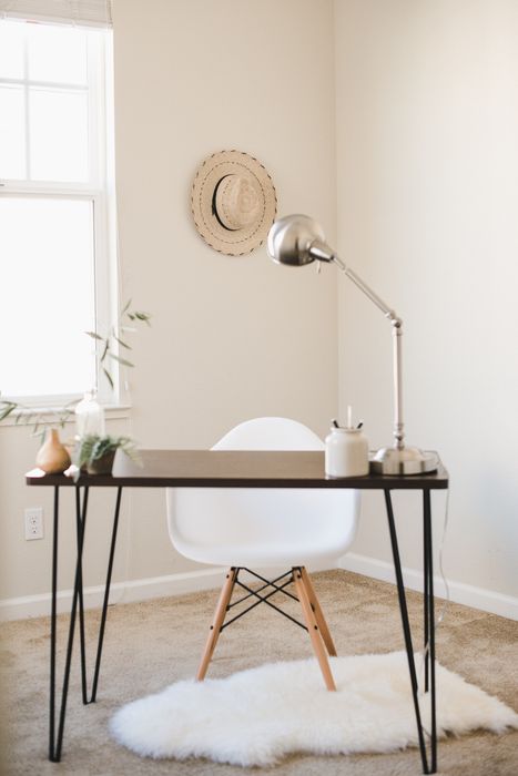 desk in bedroom with brown carpet