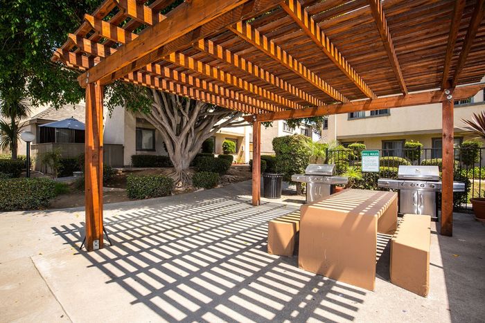 outdoor shaded seating area with grills