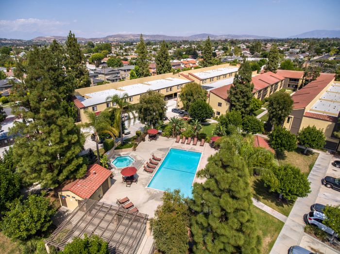 Aerial view of town and country's pool and lounge area with lush landscaping