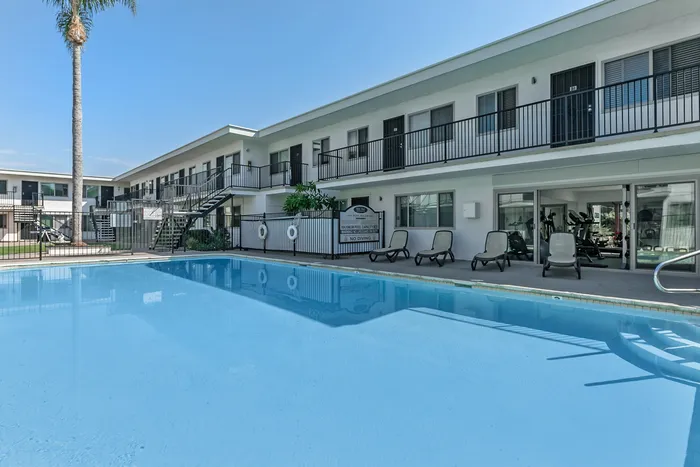 pool and lounge area with fitness center