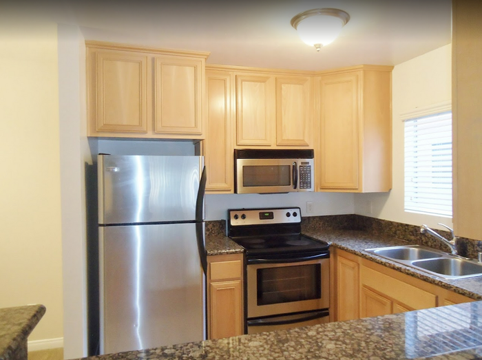 Updated kitchen with maple cabinets, stainless steel appliances, and tile flooring