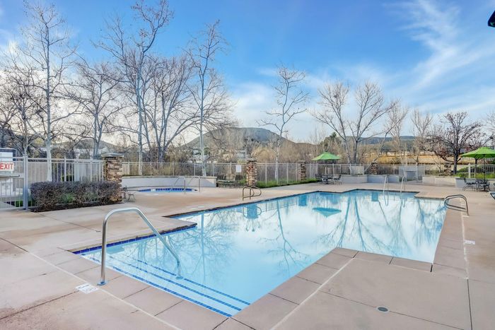 community pool and lounge areas with hot tub