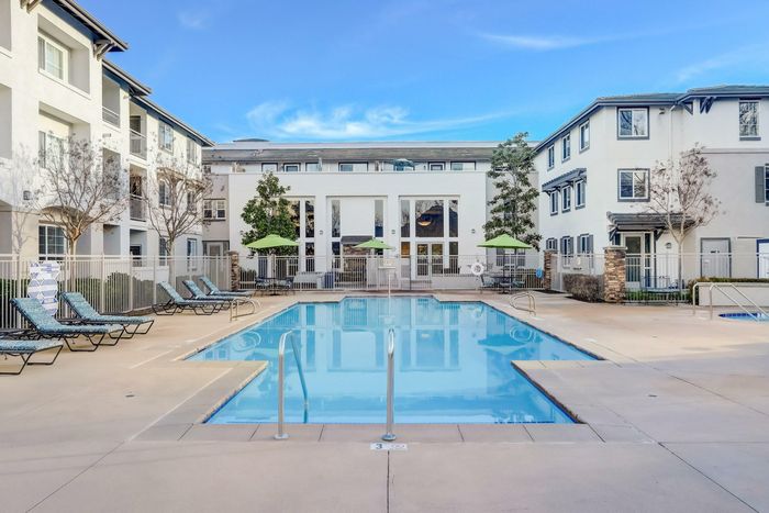 community pool and lounge areas with hot tub