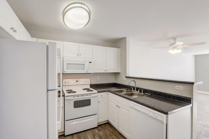 fully equipped kitchen with white cabinets