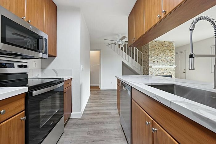 view of entry way from kitchen with vinyl wood like flooring and stainless steel appliances