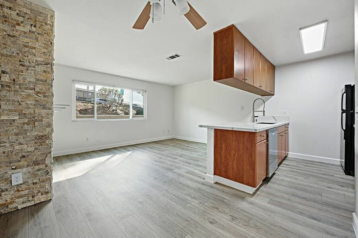 living room and kitchen with vinyl wood like flooring