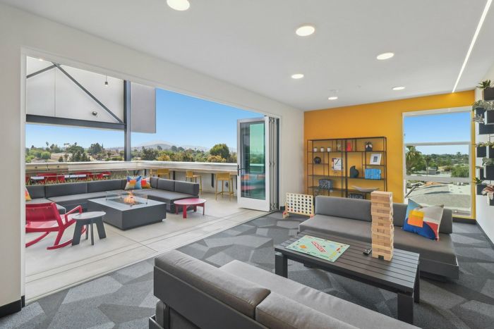 Rooftop lounge with games set-up leading out to rooftop deck at The Kelvin near La Mesa, CA