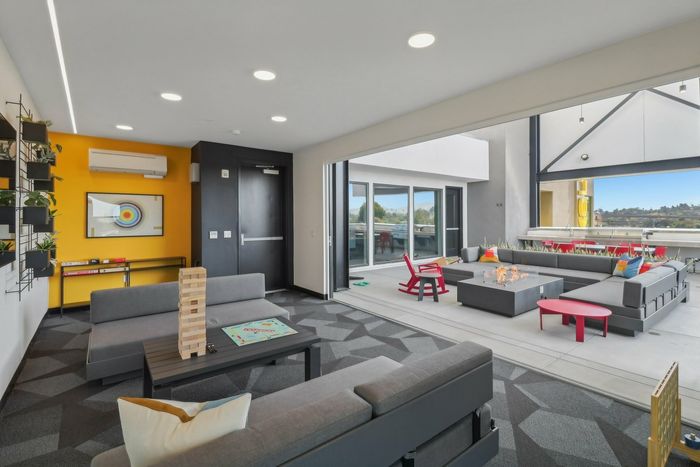 Rooftop lounge with games set-up leading out to rooftop deck at The Kelvin near La Mesa, CA