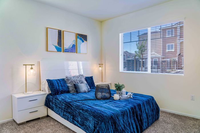 bedroom with carpeted flooring and bed with a blue comforter at Turtle Creek apartments