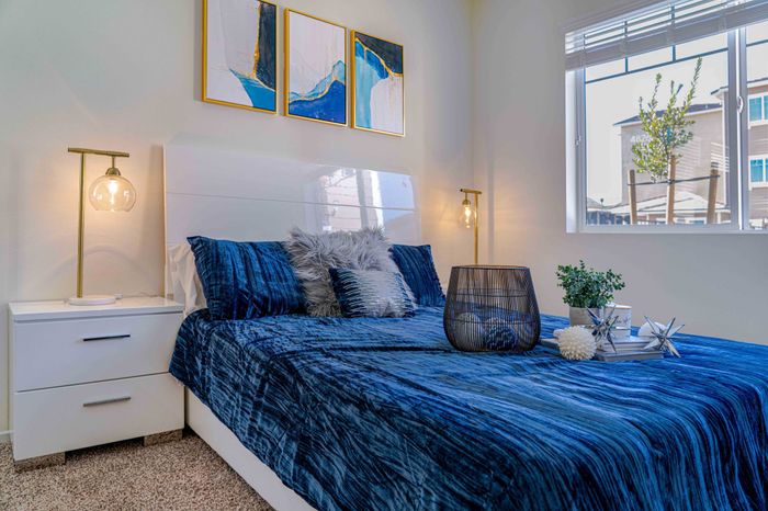 bedroom with carpeted flooring and bed with a blue comforter at Turtle Creek apartments