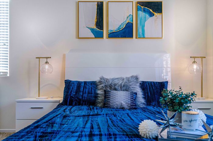 bedroom with carpeted flooring and bed with a blue comforter at Turtle Creek apartments