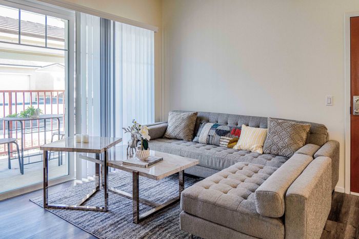 living room with wood like flooring and patio access at Turtle Creek apartments