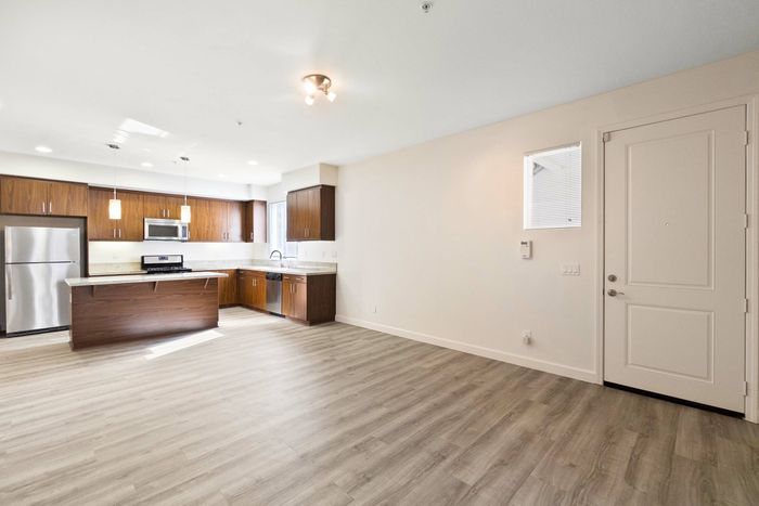 open kitchen with granite countertops and a kitchen island and stainless steel appliances