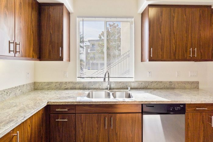 open kitchen with granite countertops and a kitchen island and stainless steel appliances