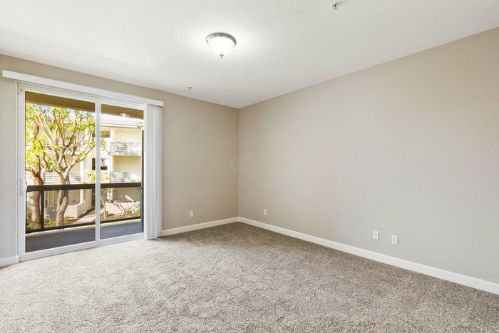 bedroom with access to patio via sliding glass door