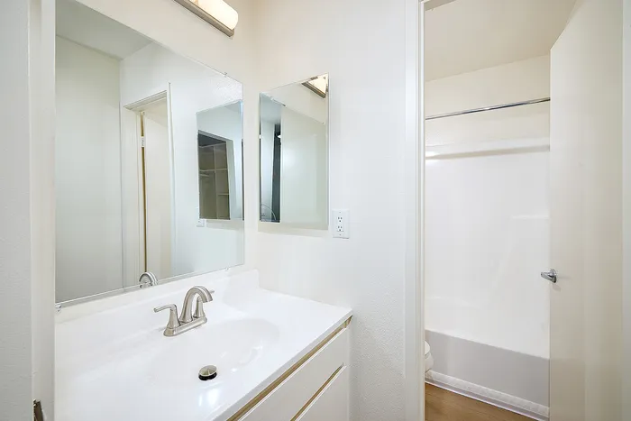 bathroom with white finishes and full shower and bathtub combo
