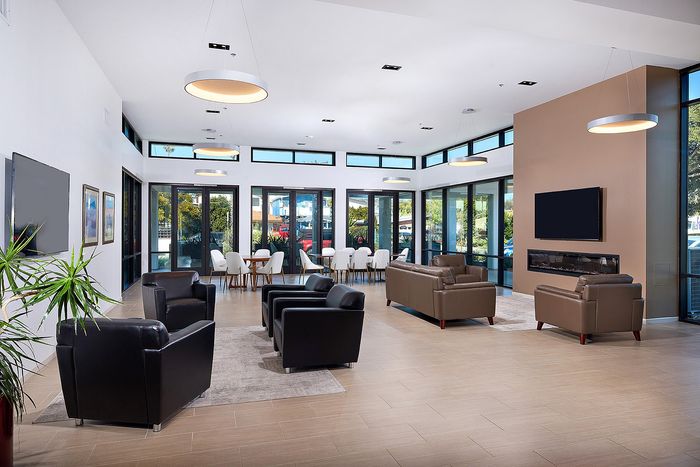 Updated Resident lounge area with fireplace, TVs, and seating