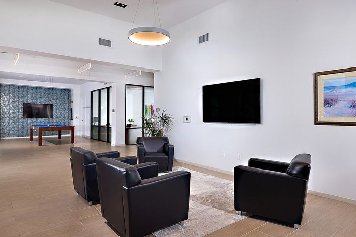 Updated Resident lounge area with fireplace, TVs, and seating