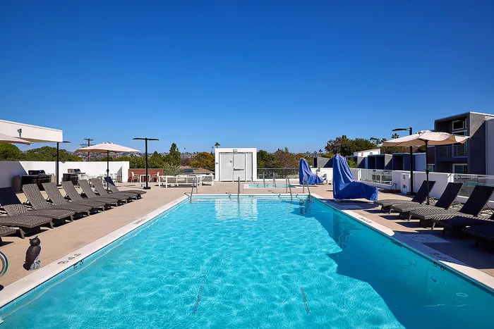 Renovated pool and lounge area on rooftop deck with expansive views
