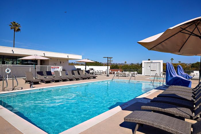 Renovated pool and lounge area on rooftop deck with expansive views