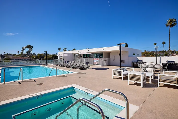 Renovated pool, lounge and spa area on rooftop deck with expansive views