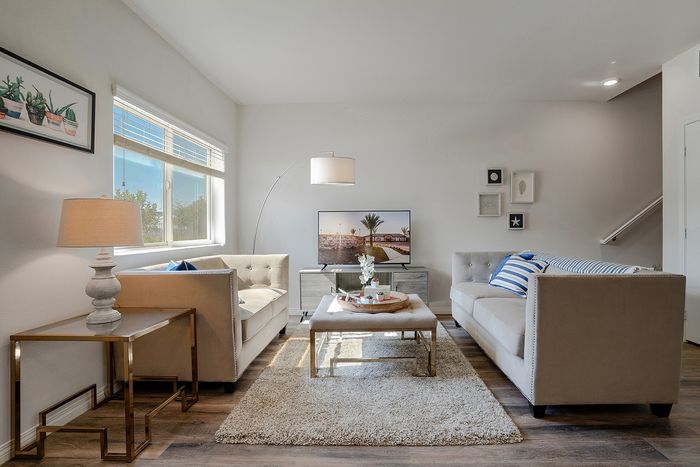 living room with taupe sofas, decorative rug and glass coffee table at Grapevine Villa