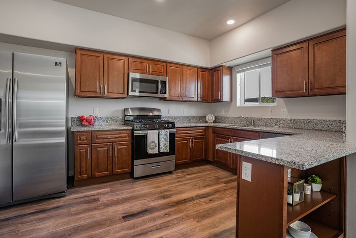 kitchen with stainless steel appliances and faux-wood like flooring