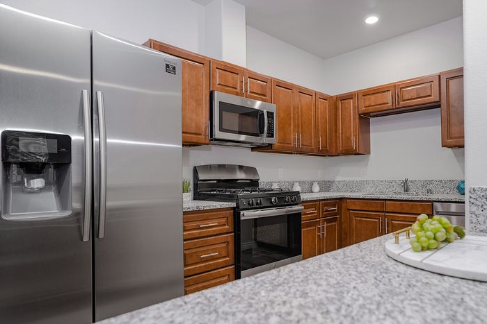 kitchen with stainless steel appliances and faux-wood like flooring