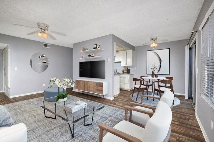 Virtually staged living room and dining area leading into the kitchen